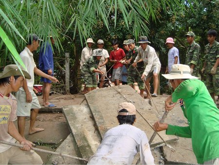 Lực lượng vũ trang cùng người dân sửa chữa đường giao thông nông thôn.