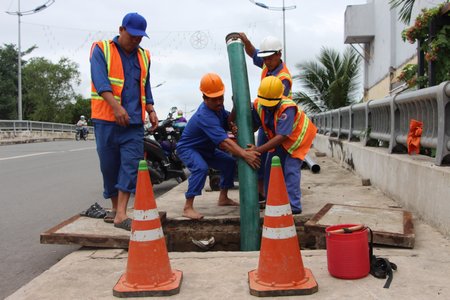 Nhân viên Công ty CP Công trình công cộng Vĩnh Long túc trực bơm thoát nước.