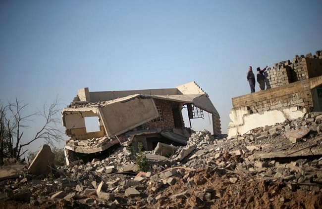 Đôi vợ chồng già bên căn nhà đổ nát vì chiến tranh tàn phá ở thị trấn Bashiqa, Mosul.