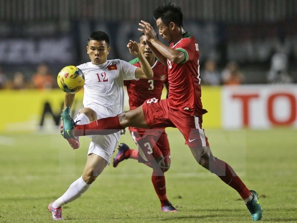 Pha tranh bóng giữa Lê Văn Thắng (trái) và cầu thủ Indonesia Stefano Lilipaly Bayu Pradana Andriatmoko (phải) trong trận đấu bán kết lượt đi. (Nguồn: AP/TTXVN)