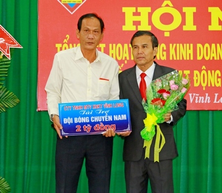 Ông Thiệu Ngọc Tâm- Giám đốc Công ty TNHH 1TV Xổ số kiến thiết Vĩnh Long (trái) trao bảng tượng trưng tiền tài trợ đội bóng chuyền nam của tỉnh 2017 cho ông Nguyễn Thanh An- Phó Giám đốc Sở Văn hoá, Thể thao và Du lịch tỉnh.