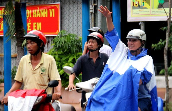 Một phụ huynh vui mừng vẫy tay khi thấy con mình từ xa.