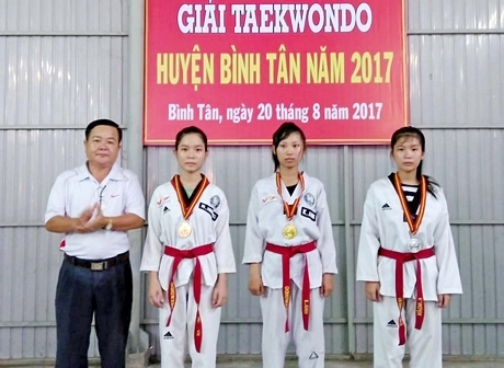 Ông Nguyễn Văn Vô- Phó Phòng VHTT huyện, Phó BTC giải trao huy chương cho các VĐV Taekwondo đạt giải. Ảnh: NGUYỄN MẪN  