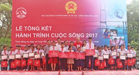 Các vị lãnh đạo và nhà tài trợ trao tặng quà cho học sinh có hoàn cảnh khó khăn và tặng 5 hợp đồng bảo hiểm nhân thọ cho các em.