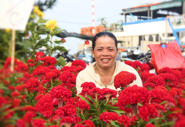 Nụ cười của chị bán bông ở chợ tết 2018. Chị rạng rỡ vì “năm nay bán tương đối khá, mong thị trường tiêu thụ mạnh để tết sung túc hơn”.