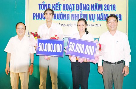 Ông Lữ Quang Ngời- Ủy viên Thường vụ Tỉnh ủy, Phó Chủ tịch UBND tỉnh Vĩnh Long (phải) và ông Nguyễn Văn Diệp- nguyên Chủ tịch UBND tỉnh, Chủ tịch Liên đoàn Bóng chuyền tỉnh (trái) trao thưởng 2 đội bóng chuyền Vĩnh Long.