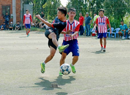 Pha tranh bóng trong trận Thành Đông (áo xanh) hòa Vĩnh Xuân 5-5.