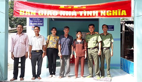 Đại diện Công an tỉnh chụp ảnh lưu niệm cùng với gia đình bà Trần Thị Phấn.