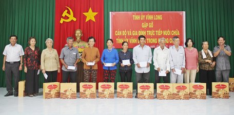 Đồng chí Nguyễn Tấn Lực- Tỉnh ủy viên, Bí thư Huyện ủy Châu Thành- Đồng Tháp (bìa phải) và đồng chí Đoàn Minh Lý- Ủy viên Thường vụ Tỉnh ủy, Giám đốc Công an tỉnh trao quà đến các hộ gia đình. 