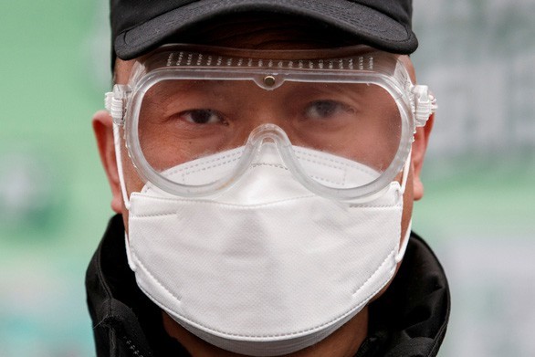 Một nhân viên bảo vệ tại xưởng sản xuất Mengniu Dairy, Bắc Kinh. Ảnh: Reuters.