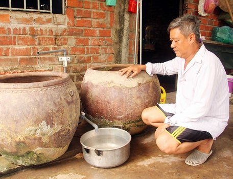 Hạn mặn gay gắt, nhiều nơi gặp khó khăn về nguồn nước tưới cho cây trồng và cả nước sinh hoạt. Trong ảnh: Ông Quách Văn Mười mở sẵn vòi để canh hứng nước nhưng nước máy cũng chỉ nhỏ giọt.