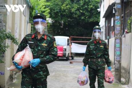 Các chiến sĩ cùng lực lượng cơ sở “đi từng ngõ, gõ từng nhà” trao từng phần quà hỗ trợ người dân gặp khó khăn.