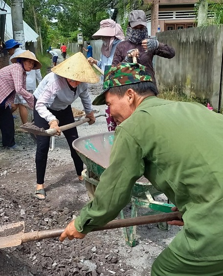 Bà con lối xóm chung tay giặm vá lối đi chung.